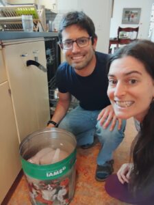 Athena and her brother with a turkey in a bucket that used to be a dog food bucket.
